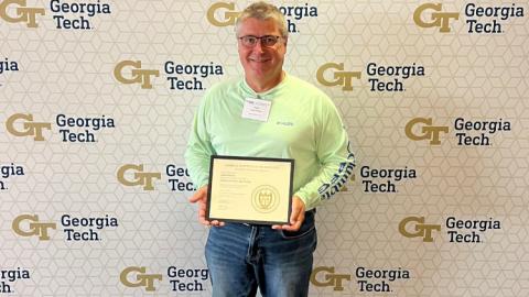 Man holding a framed certificate