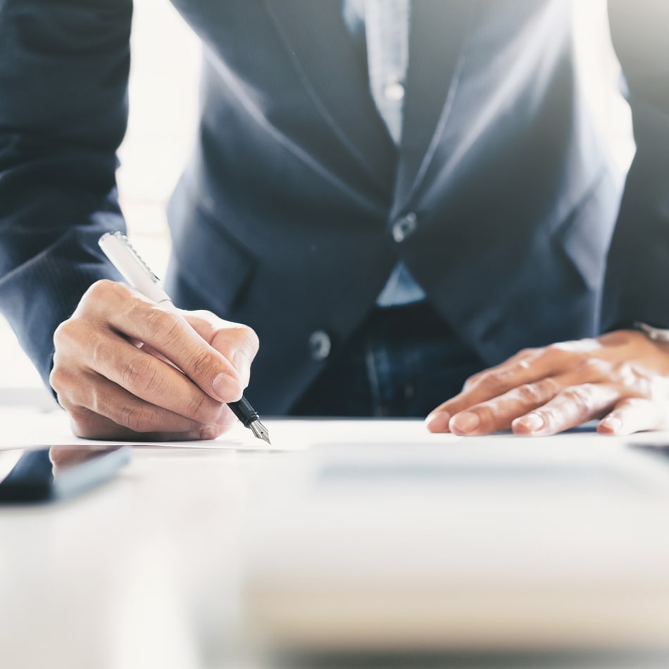 Working professional signing a document
