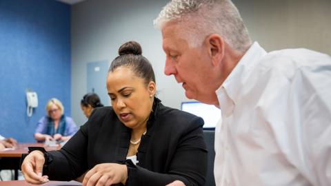 Management professionals collaborating in classroom