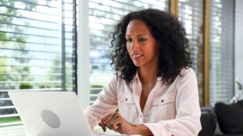 African American working professional working and learning on laptop computer