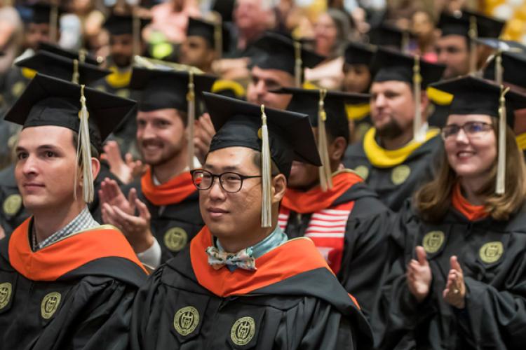 Georgia Tech grads in cap and gown during a commencement ceremony.