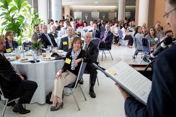 Attendees sitting around tables at conference meeting