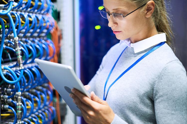 Female professional in computer science lab looking at tablet