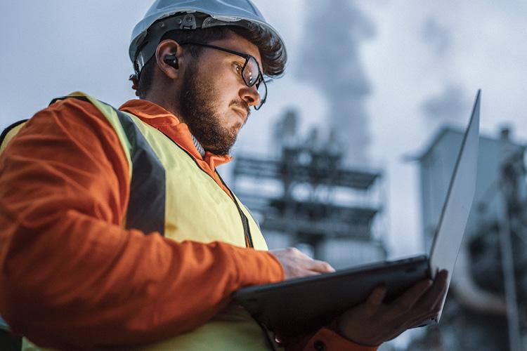 Chemical engineer analyzing data on job site