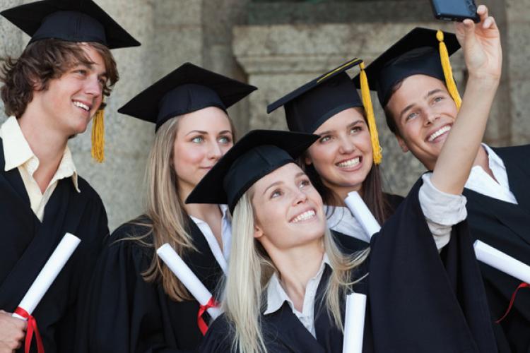 Students in gap and gowns posing for a picture