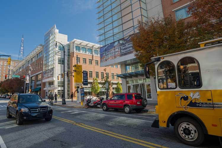 Exterior of the Georgia Tech Global Learning Center with the Tech Trolley parked outside