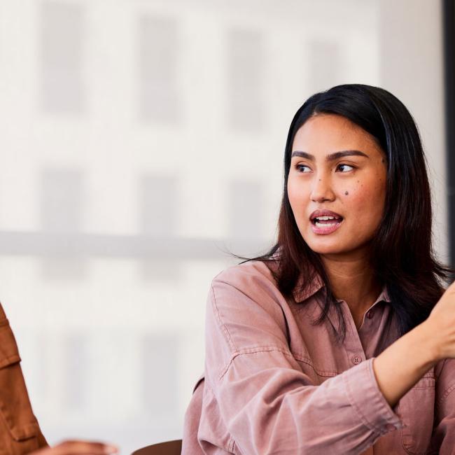 A man and woman discussing topics in the workplace